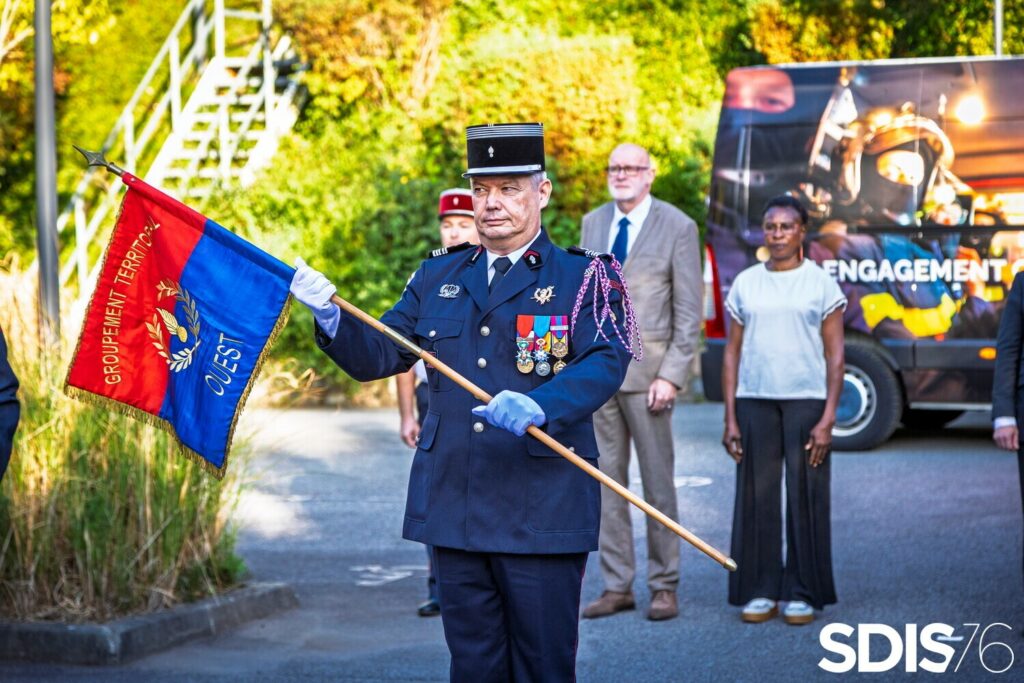 Le colonel hors classe Eric JOUANNE porte le fanion du groupement Ouest